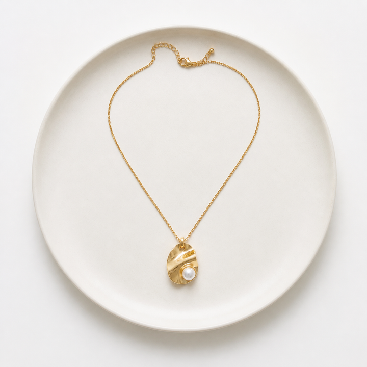 Rare Matters necklaces displayed on a white ceramic plate