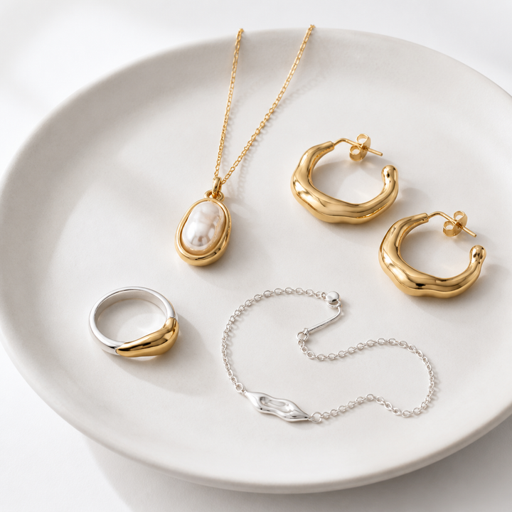 Rare Matters new arrivals jewelry displayed on a white ceramic plate
