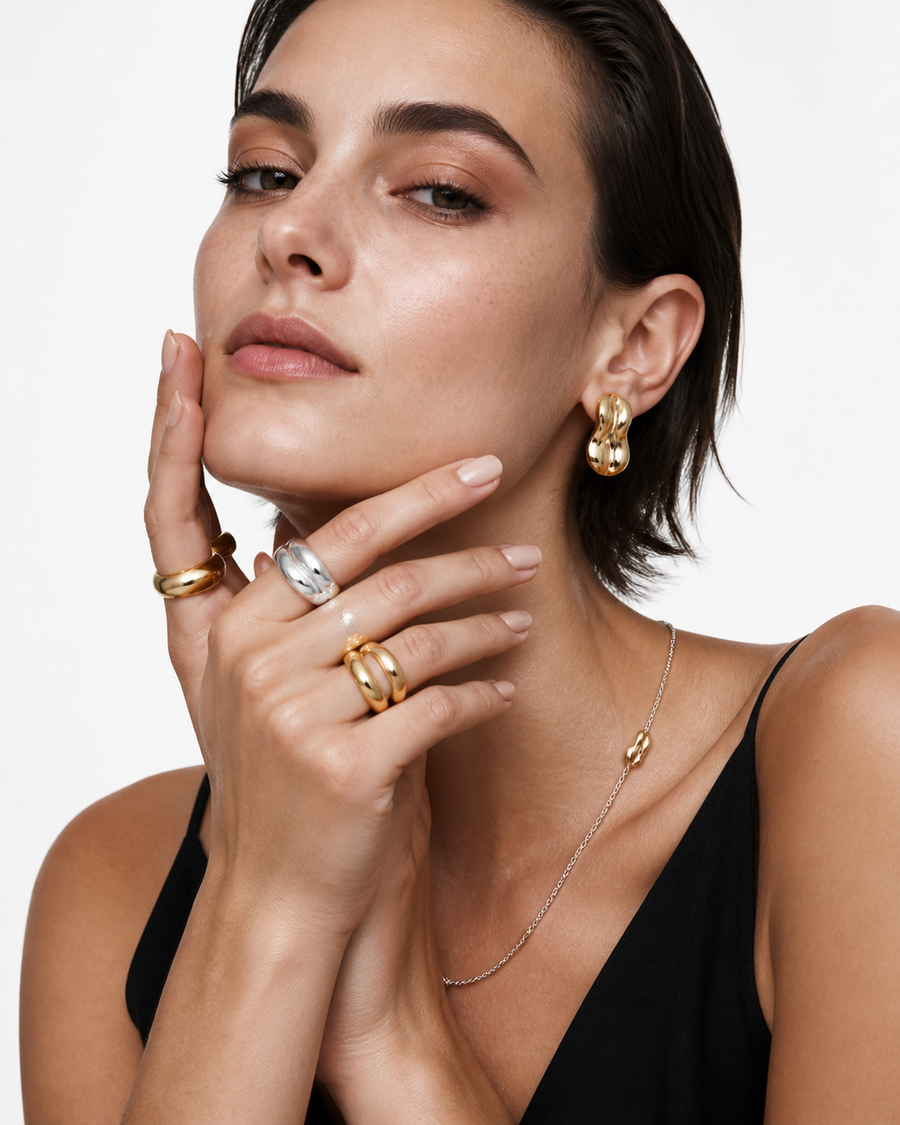 Model wearing Rare Matters sculptural earrings, rings, and necklace for evening styling